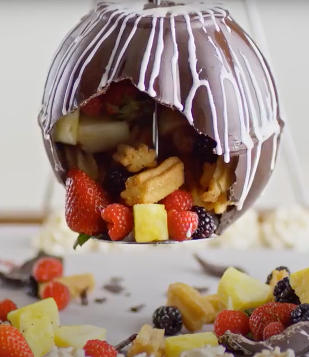 chocolate piñata filled with churros and fruit
