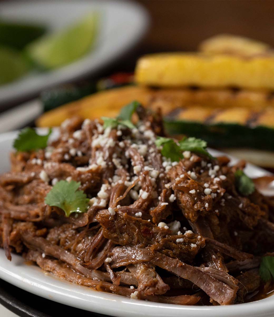 barbacoa beef on a plate with vegetables