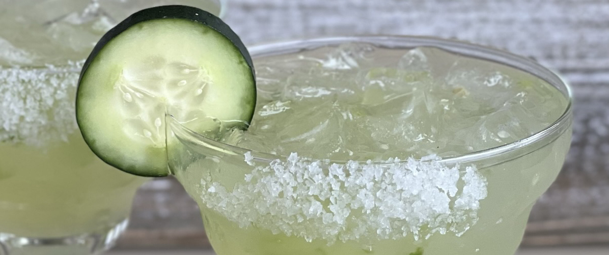 Cucumber Jalapeno margarita with salt and cucumber on the rim of the glass