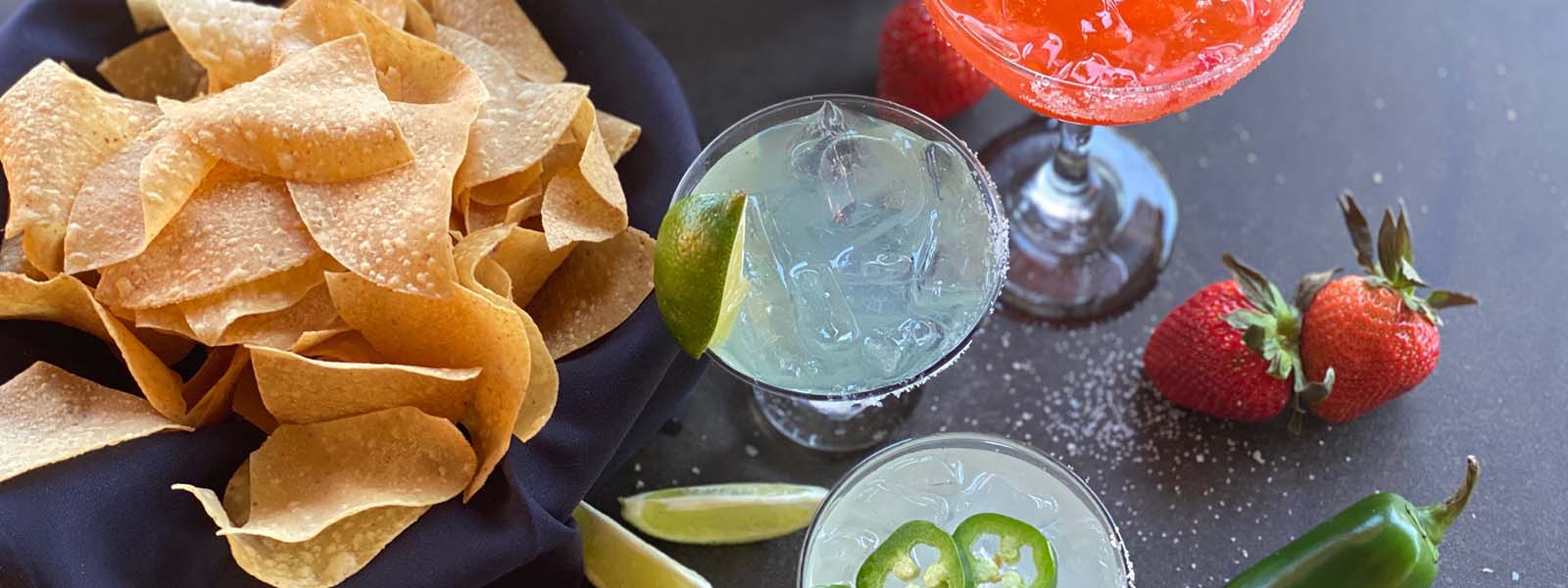 Chips and Three margaritas on a table