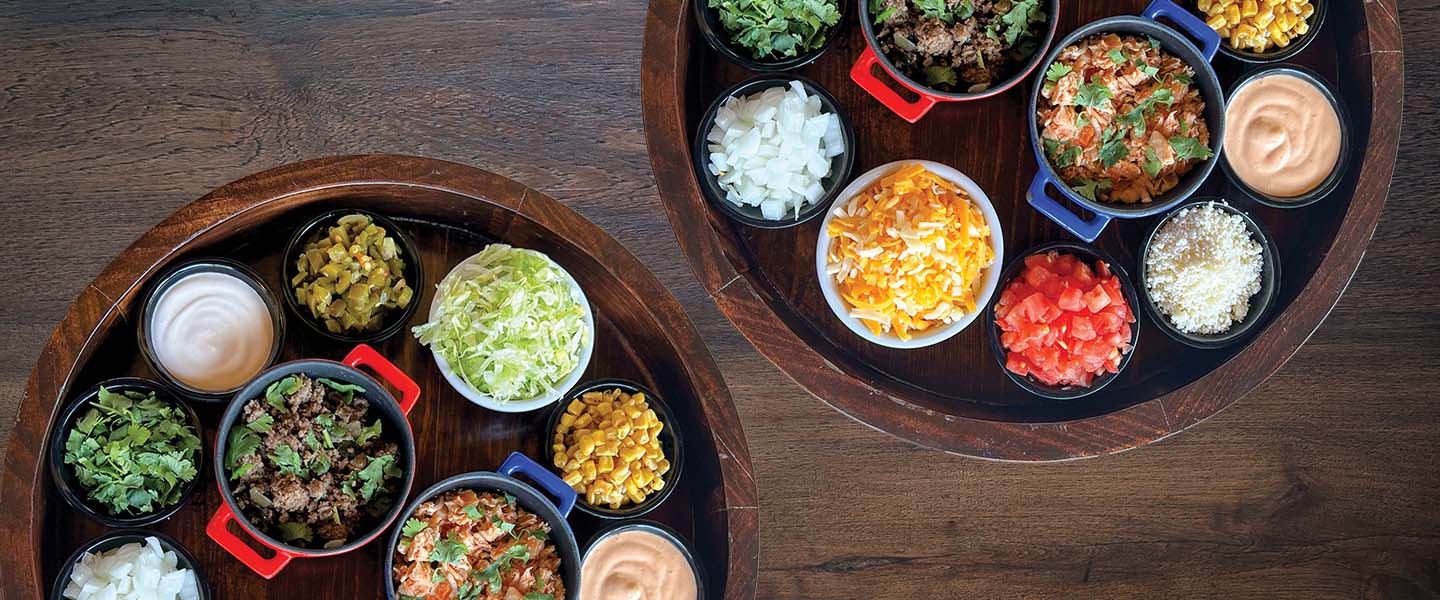 Two Taco Bar trays sitting on wood table