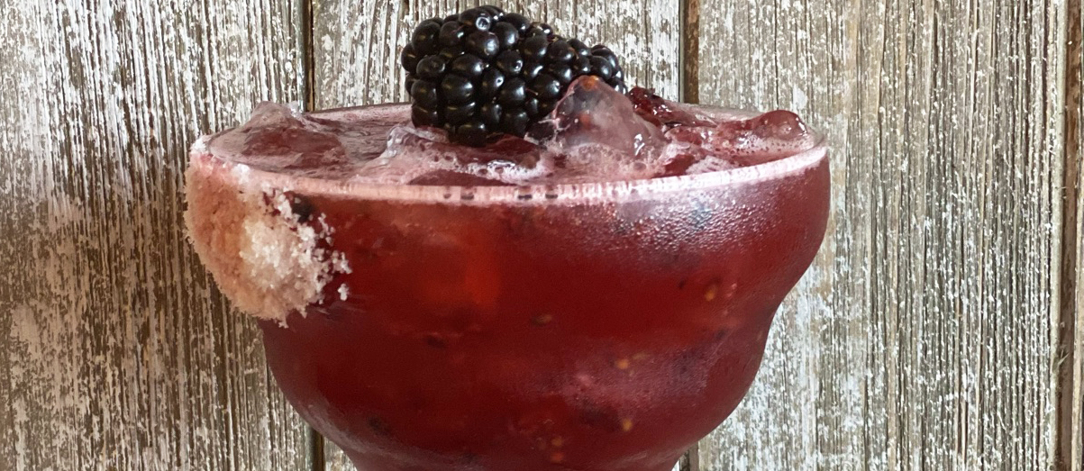 Uncle Julio's Blackberry Margarita with a blackberry on top.