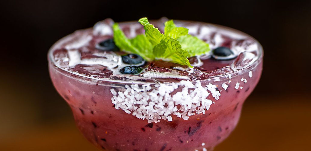 blueberry margarita garnished with fresh mint leaves
